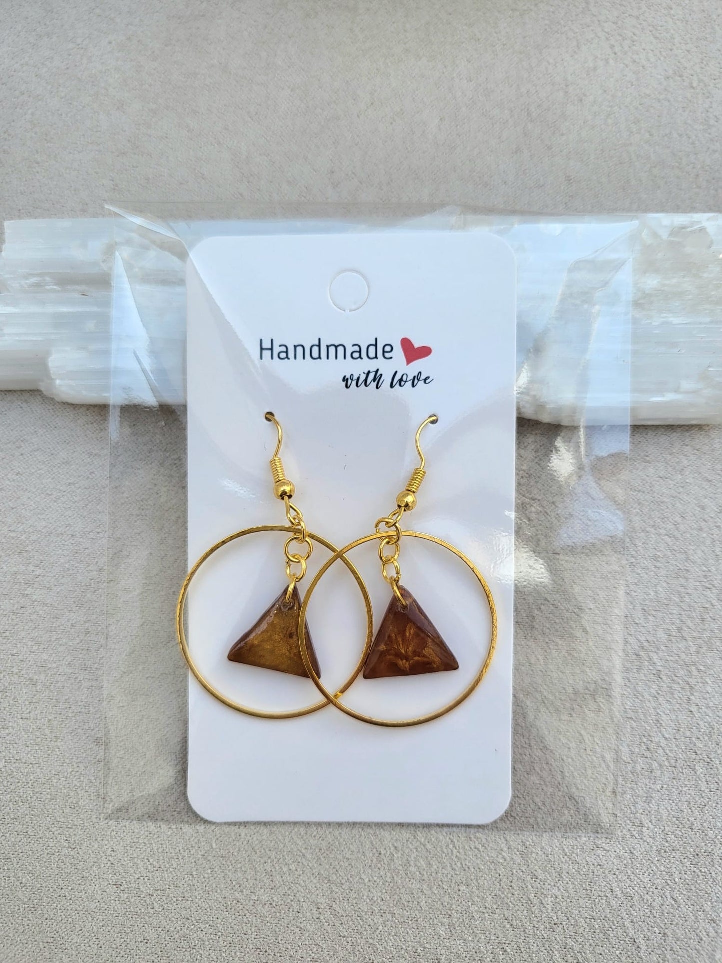 TRIANGLE ORBIT COFFEE earrings.