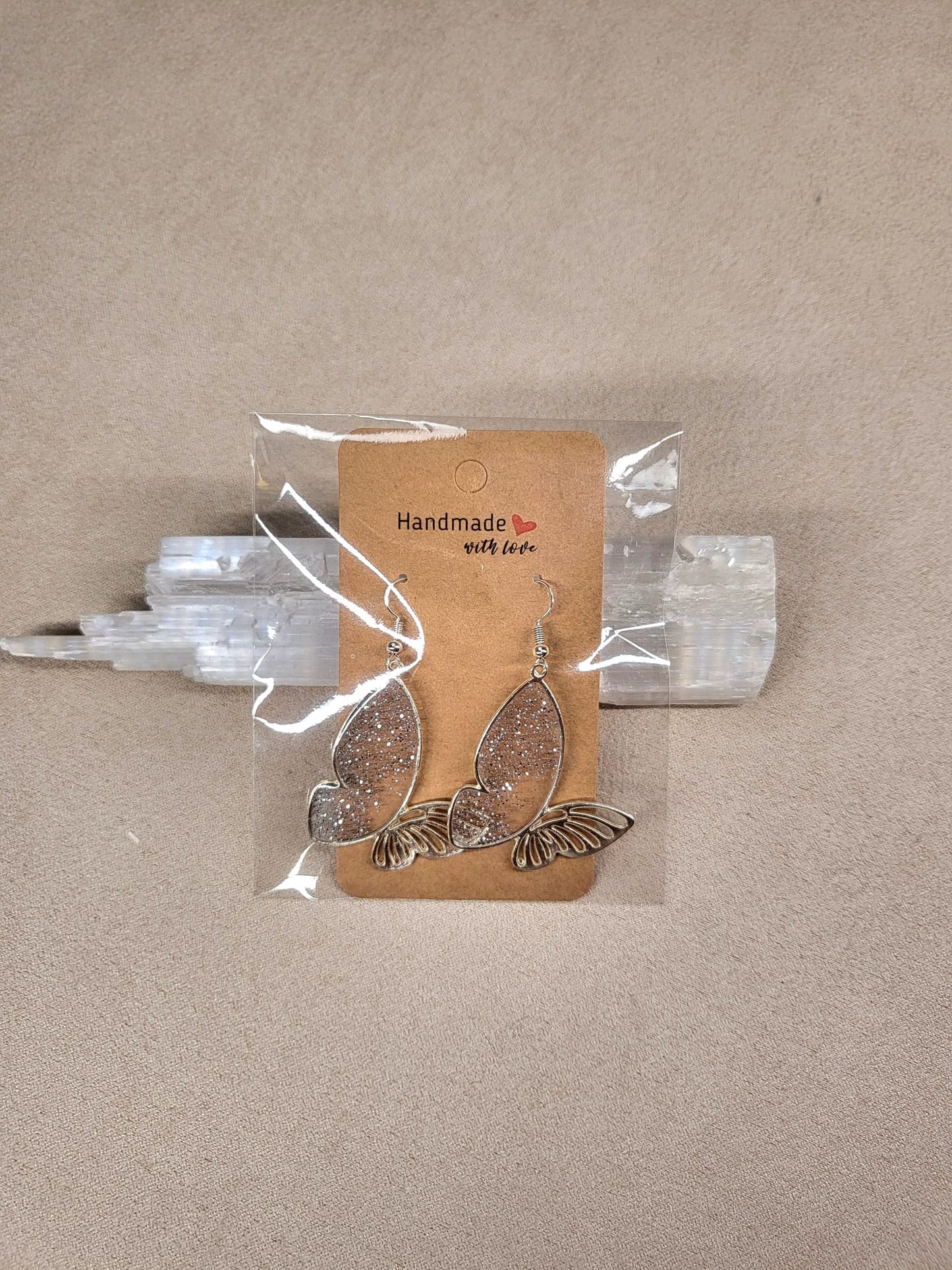 SILVER BUTTERFLY earrings.